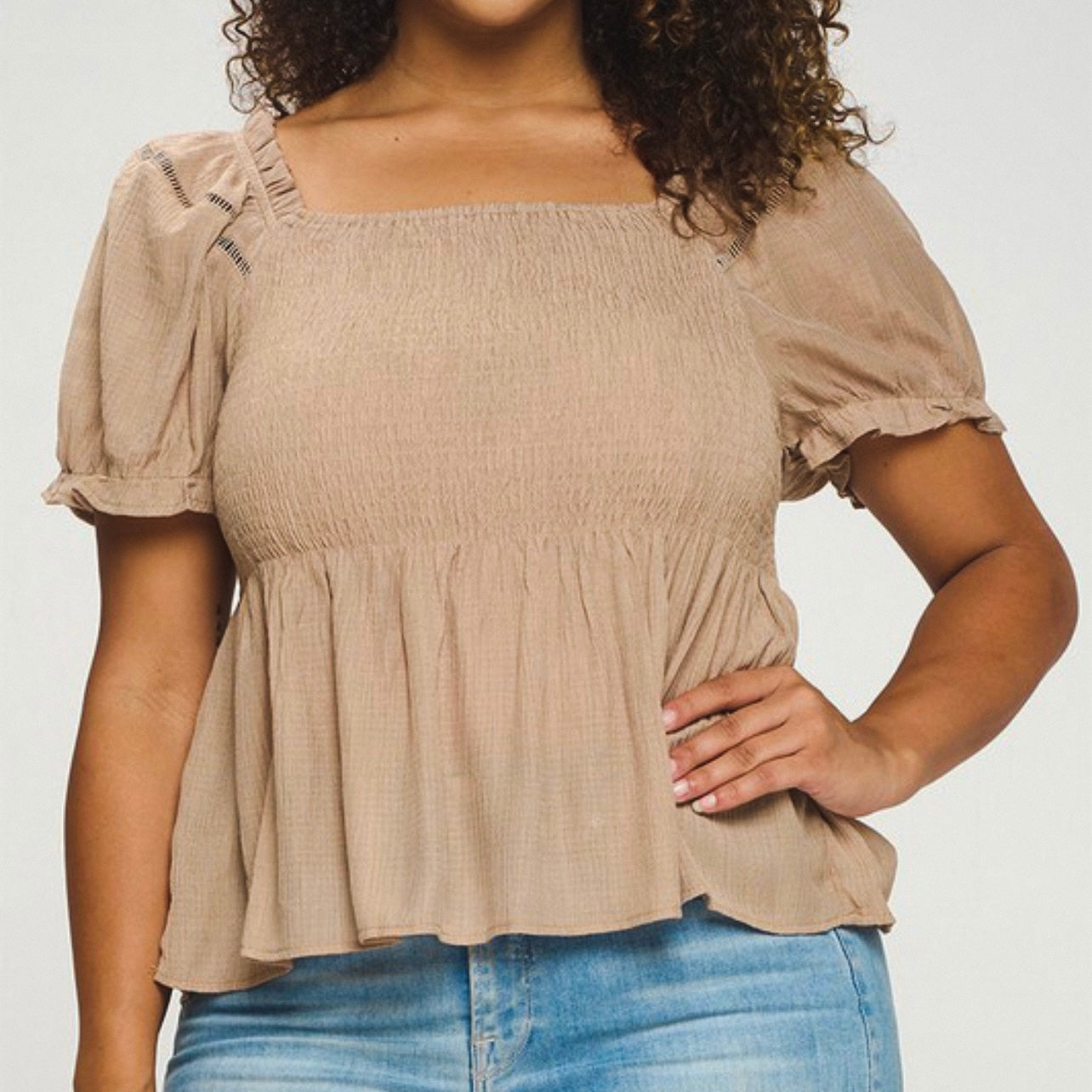 Mocha puff sleeve top with a square neckline, a shirred bodice, and a puplum style. This has a very nice stretch to it & is sheer material where it flares out under the bust. 
