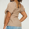 Mocha puff sleeve top with a square neckline, a shirred bodice, and a puplum style. This has a very nice stretch to it & is sheer material where it flares out under the bust. 